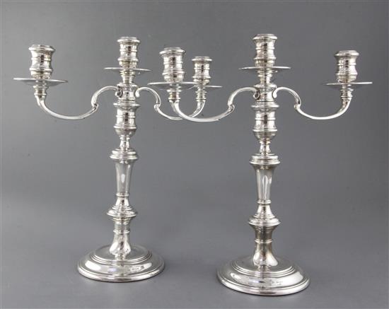 A pair of late 1970s silver two branch three light candelabra by William Comyns & Sons Ltd, height 34.8cm.